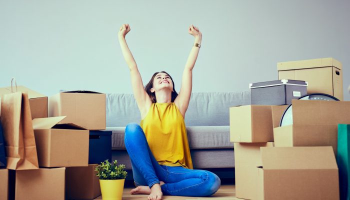 Happy young woman moving to new home - having fun